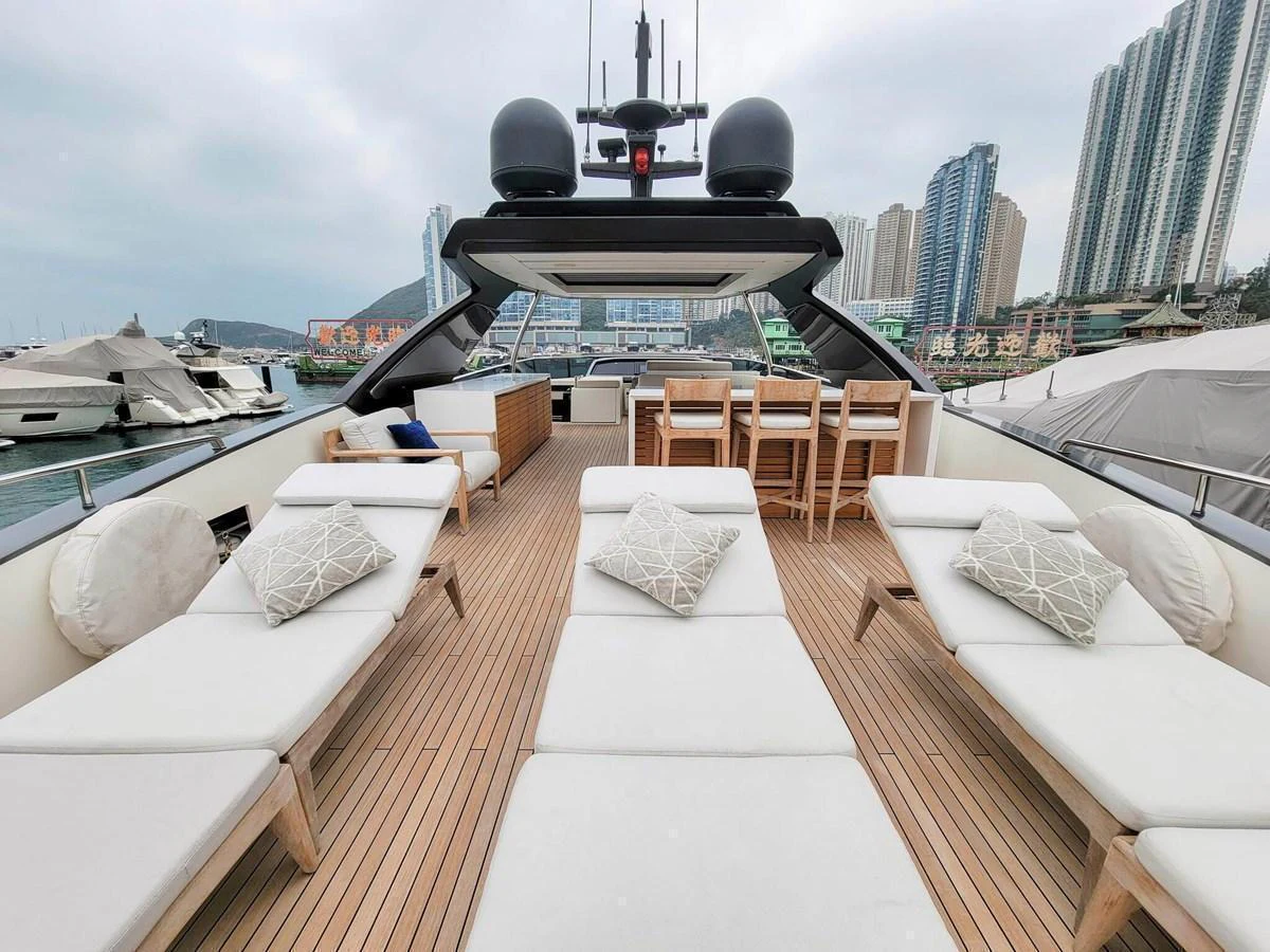 The flybridge offers a spacious and inviting area with sun loungers and a dining table, perfect for relaxation and socializing. aboard SANLORENZO SL86 Yacht for Sale