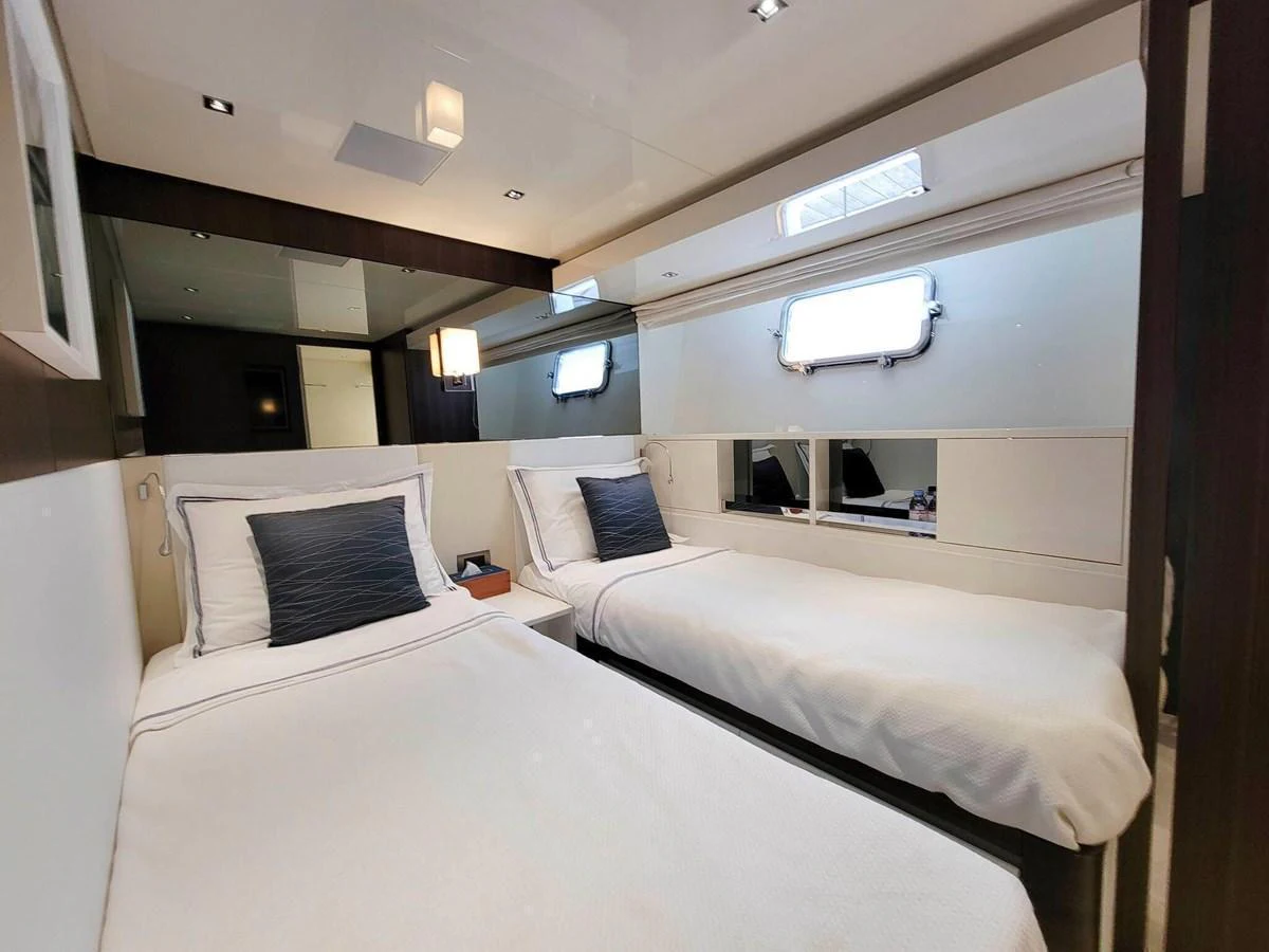 The twin stateroom offers a cozy and modern sleeping area with two single beds and elegant decor. aboard SANLORENZO SL86 Yacht for Sale