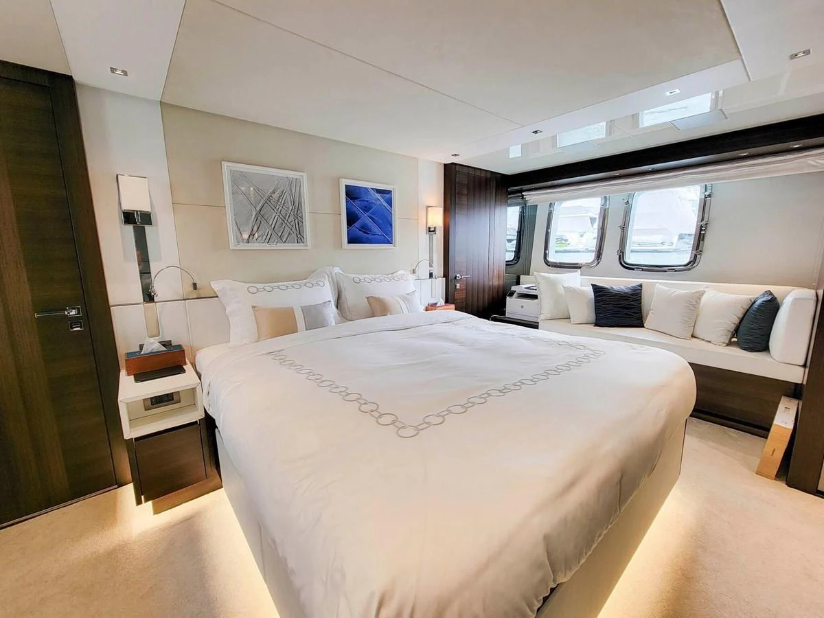 The master stateroom features a spacious bed, modern decor, and ample natural light from large windows. aboard SANLORENZO SL86 Yacht for Sale