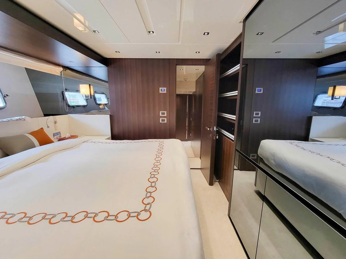 The stateroom features a luxurious bed with elegant linens and ample storage space. aboard SANLORENZO SL86 Yacht for Sale