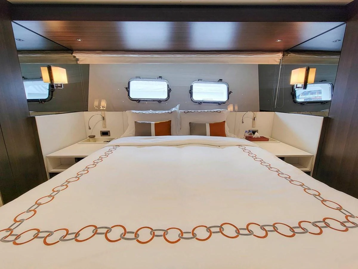 The stateroom features a luxurious bed with elegant linens and ample natural light from the portholes. aboard SANLORENZO SL86 Yacht for Sale