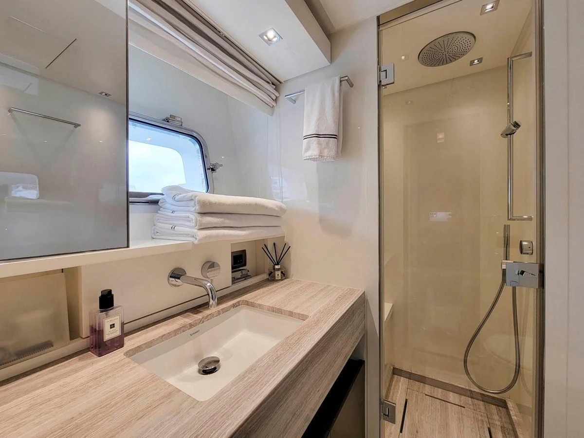 The yacht's bathroom features a sleek design with a modern sink and a spacious shower area. aboard SANLORENZO SL86 Yacht for Sale