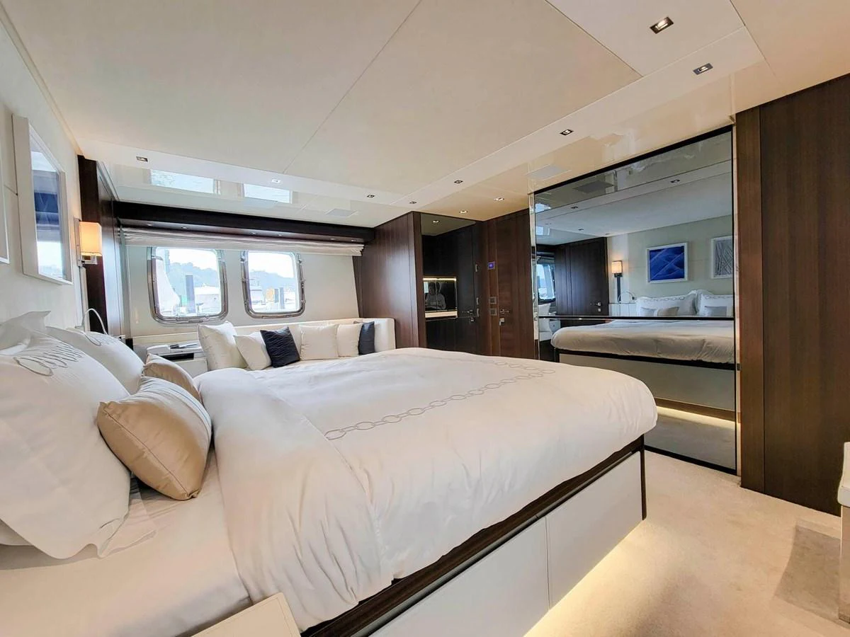 The master stateroom features a luxurious bed with elegant bedding and ample natural light from large windows. aboard SANLORENZO SL86 Yacht for Sale