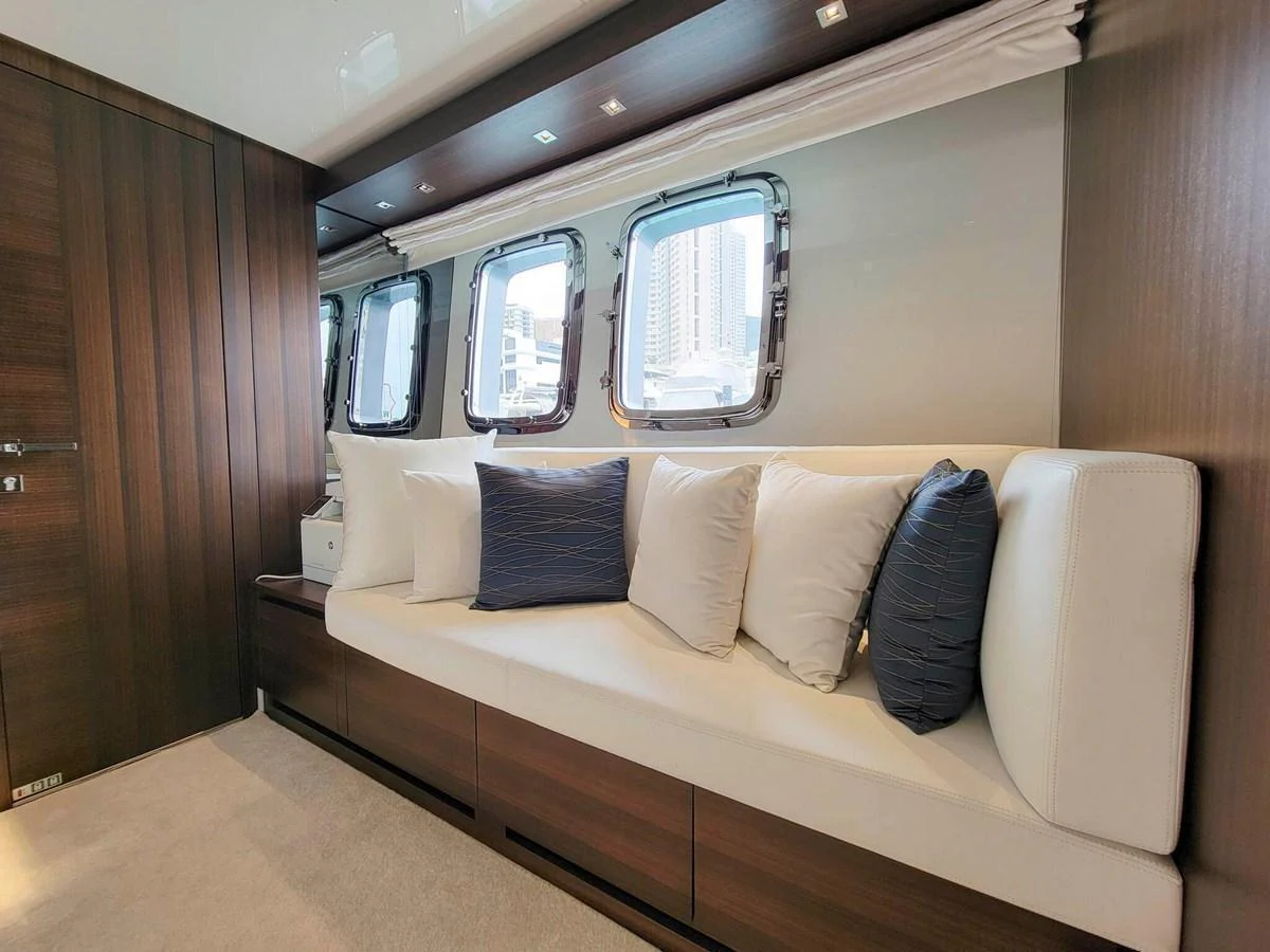 The salon features a comfortable seating area with large windows providing ample natural light. aboard SANLORENZO SL86 Yacht for Sale
