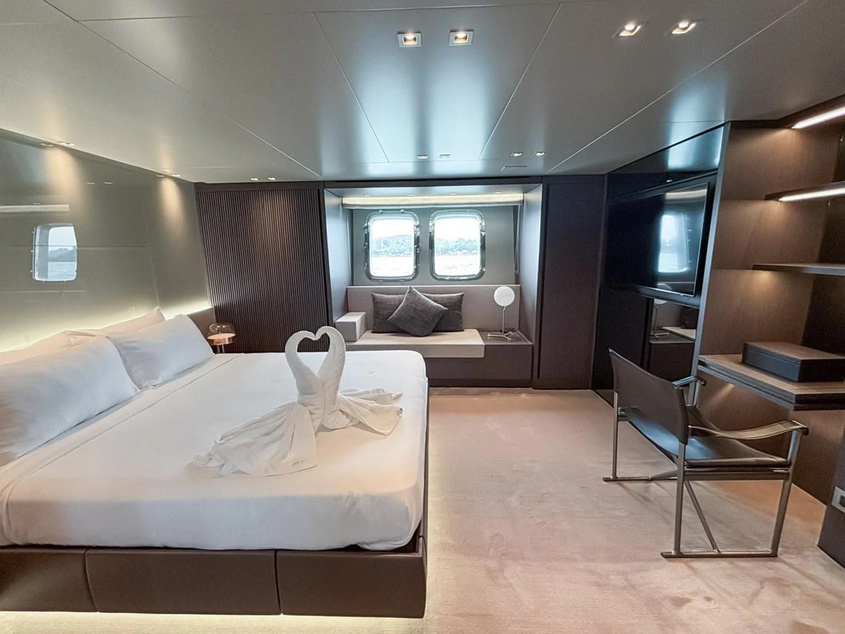 The master stateroom features a luxurious bed, elegant seating area, and modern decor. aboard SANLORENZO SX88 Yacht for Sale