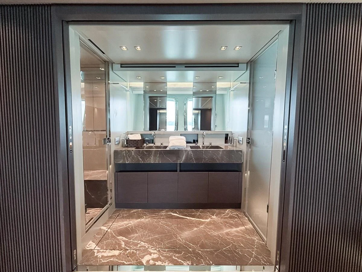 A luxurious bathroom with marble flooring and modern fixtures. aboard SANLORENZO SX88 Yacht for Sale