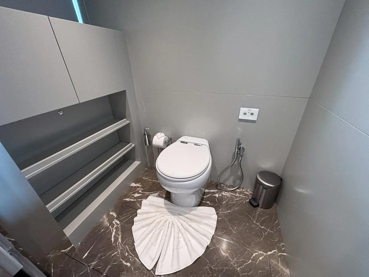 A modern yacht bathroom with sleek design and marble flooring. aboard SANLORENZO SX88 Yacht for Sale