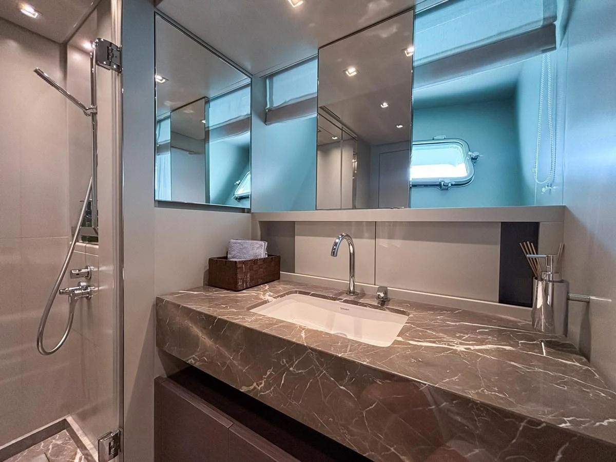The yacht's bathroom features a sleek design with a marble countertop and modern fixtures. aboard SANLORENZO SX88 Yacht for Sale