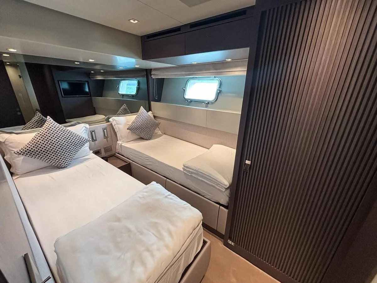 The guest stateroom features twin beds, modern decor, and ample natural light from a side window. aboard SANLORENZO SX88 Yacht for Sale