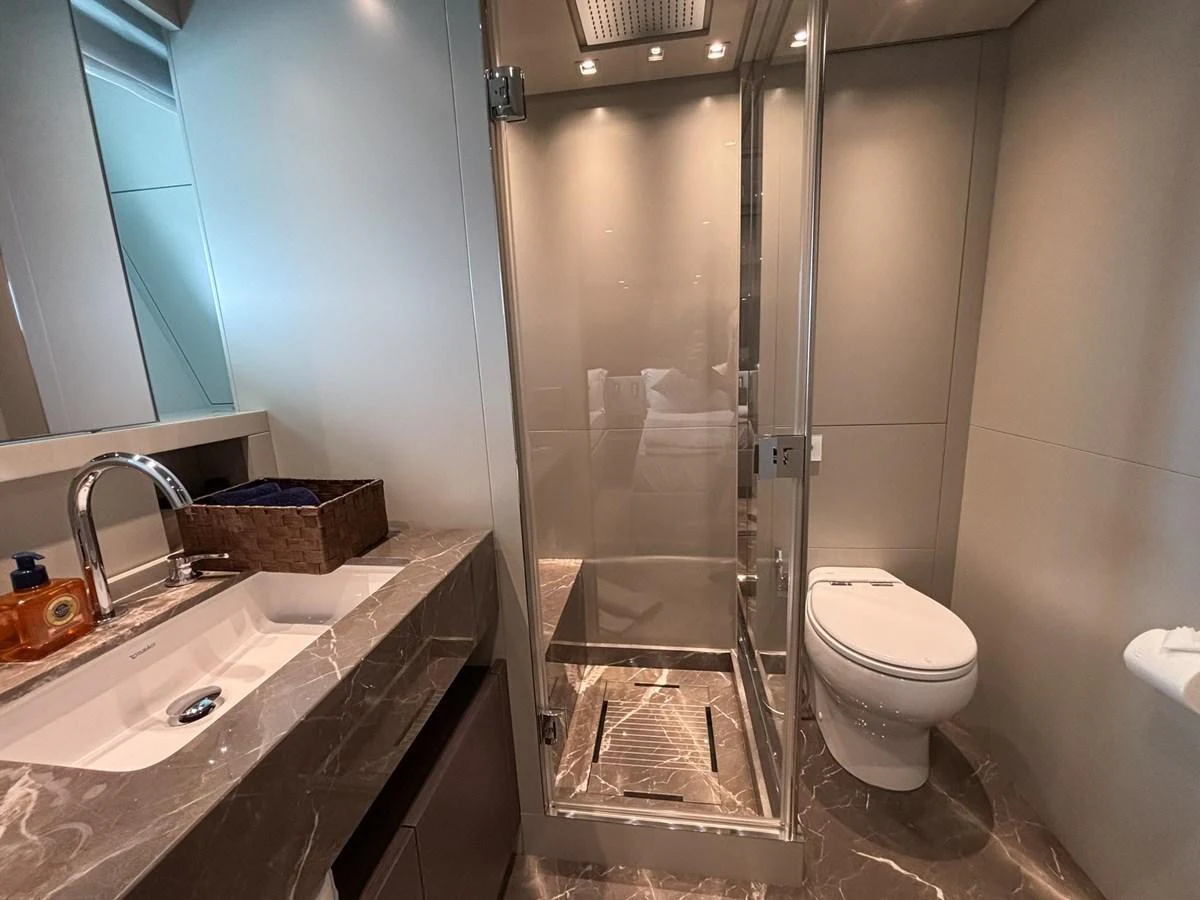 The yacht's bathroom features a sleek design with a glass-enclosed shower and modern fixtures. aboard SANLORENZO SX88 Yacht for Sale