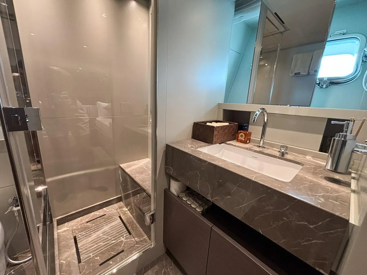 The bathroom features a sleek design with a spacious shower and modern fixtures. aboard SANLORENZO SX88 Yacht for Sale