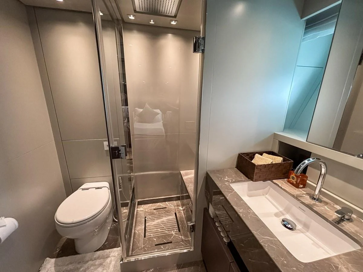 A sleek and modern yacht bathroom with a glass-enclosed shower and elegant fixtures. aboard SANLORENZO SX88 Yacht for Sale