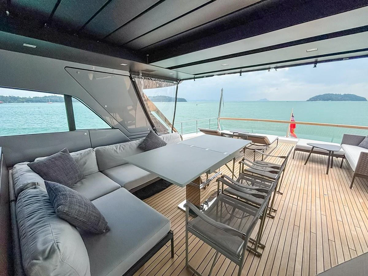 The aft deck features a spacious seating area with a dining table, offering stunning views of the surrounding waters. aboard SANLORENZO SX88 Yacht for Sale