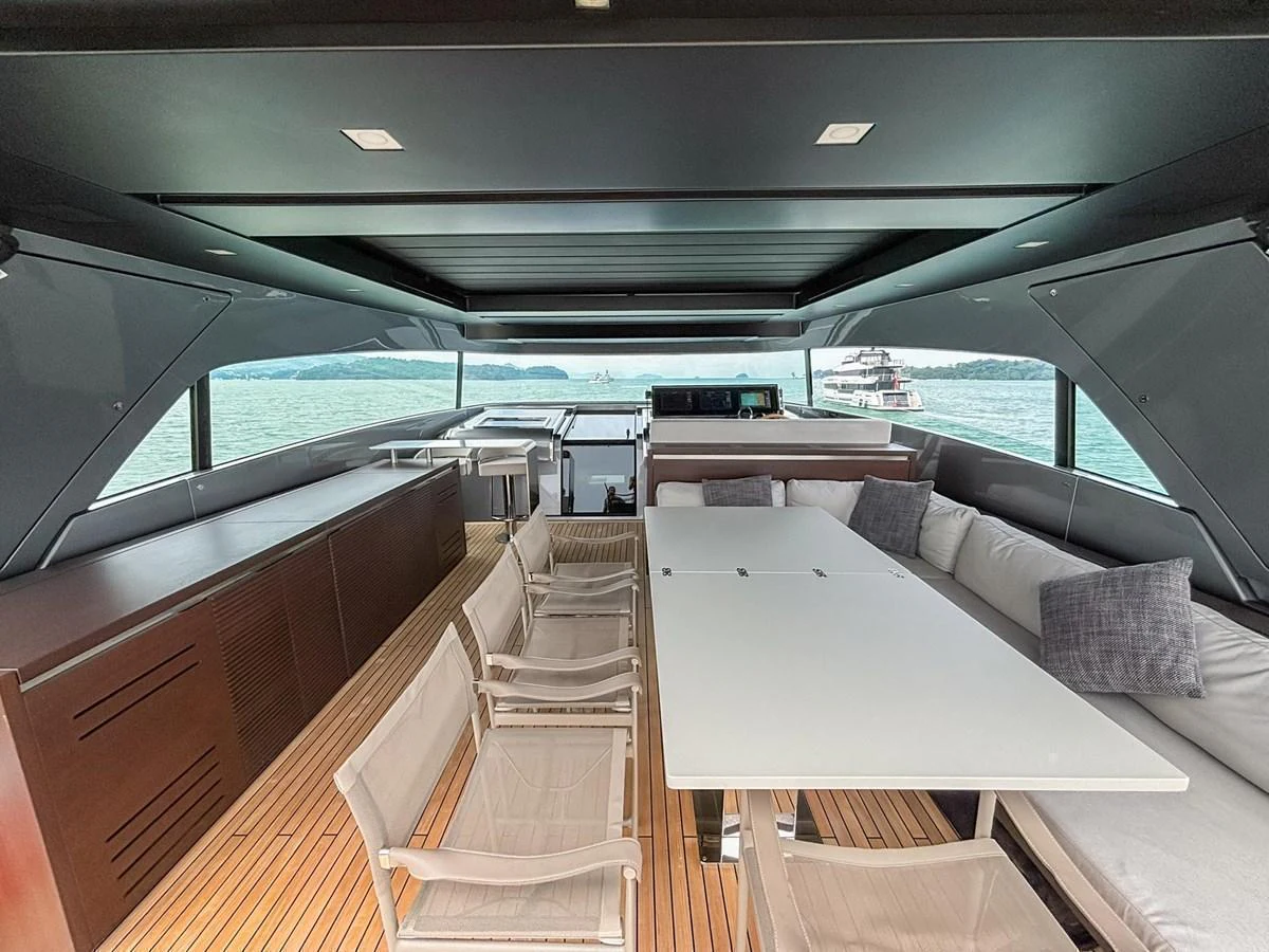 The aft deck features a spacious seating area with a dining table and comfortable chairs. aboard SANLORENZO SX88 Yacht for Sale
