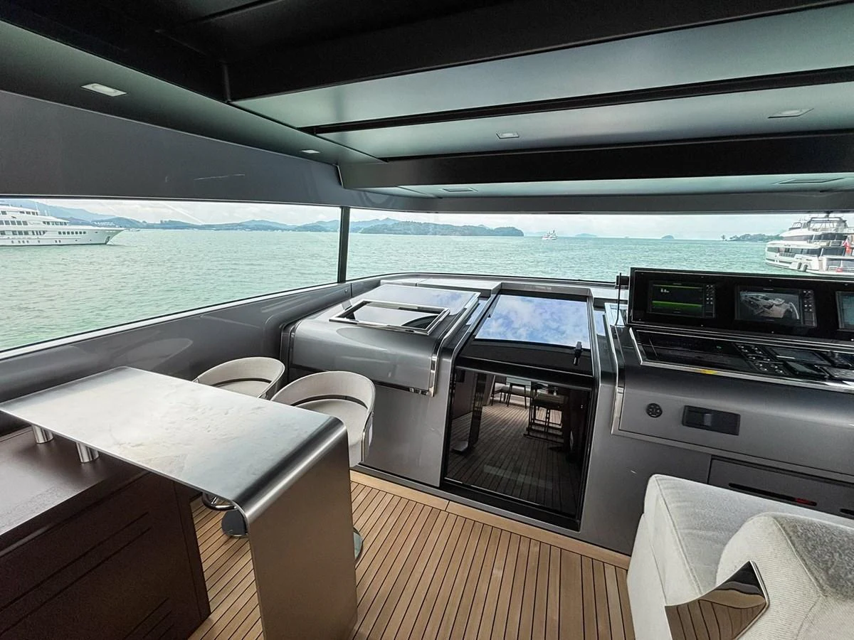 The helm area offers a sleek and modern design with expansive views of the water. aboard SANLORENZO SX88 Yacht for Sale