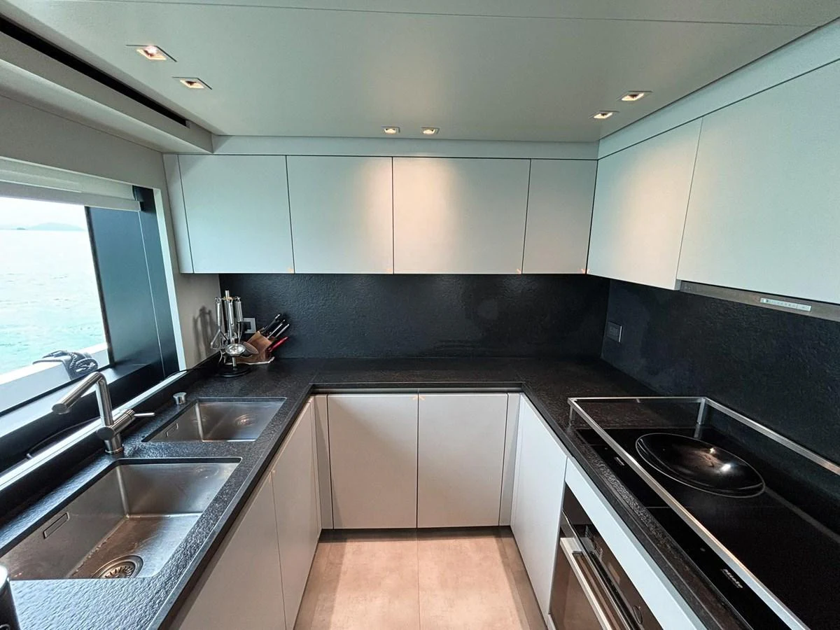 The modern galley features sleek cabinetry and high-end appliances, perfect for gourmet cooking at sea. aboard SANLORENZO SX88 Yacht for Sale