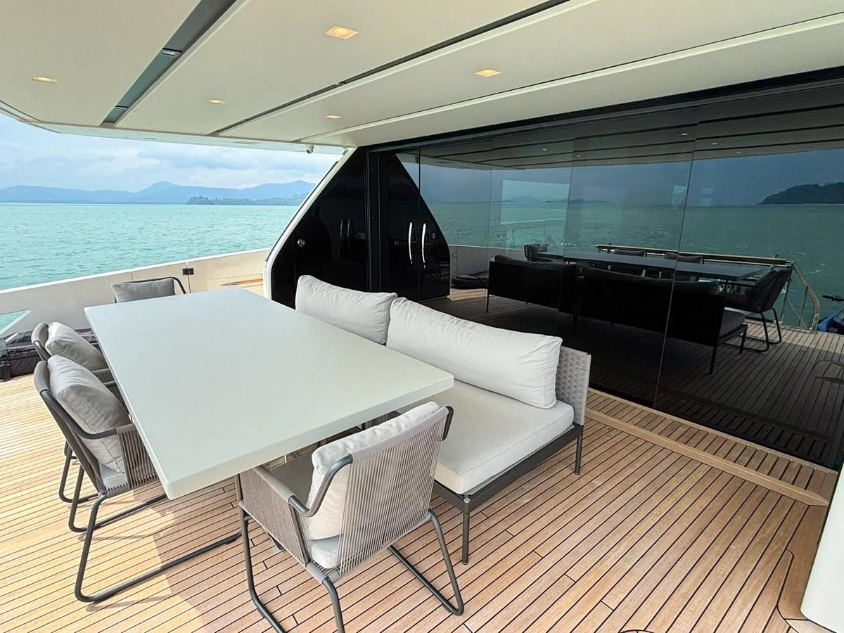 The aft deck features a stylish outdoor dining area with comfortable seating and a sleek table, perfect for alfresco meals with a view. aboard SANLORENZO SX88 Yacht for Sale