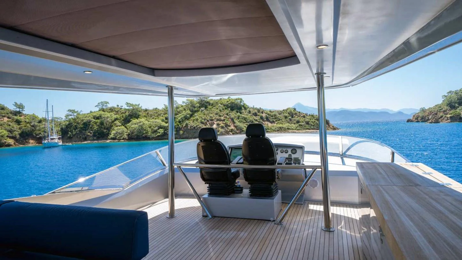 The helm area offers a panoramic view of the serene waters and lush surroundings. aboard SILVER Yacht for Sale