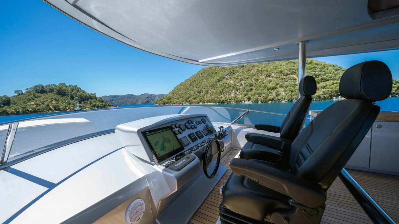 The helm station offers a commanding view of serene waters and lush landscapes. aboard SILVER Yacht for Sale