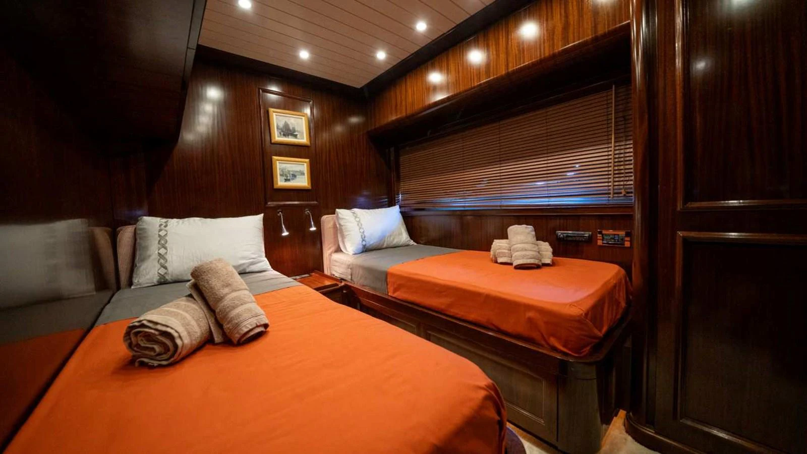 The guest stateroom features twin beds with rich wood paneling and warm lighting. aboard SILVER Yacht for Sale