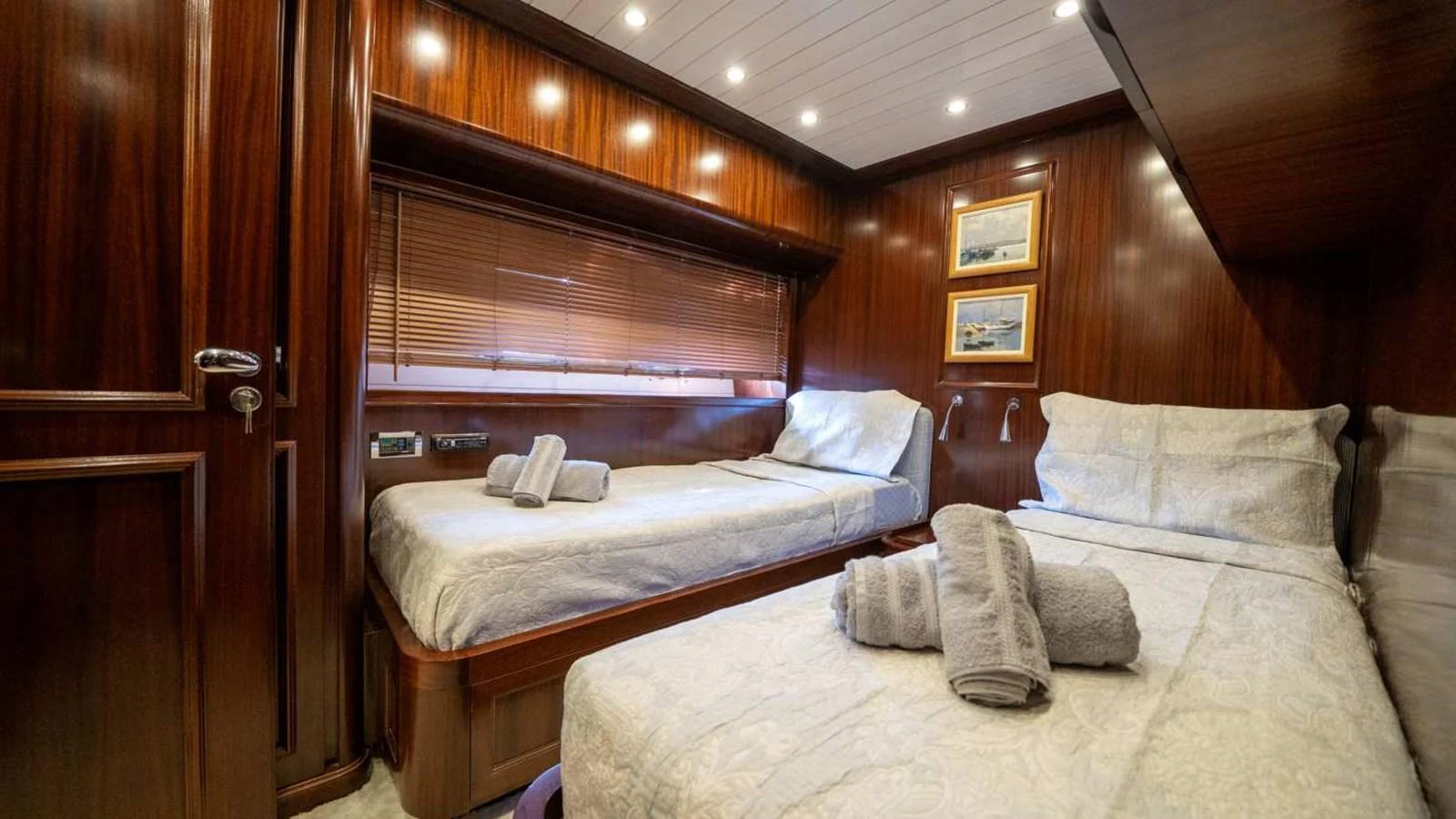 The guest stateroom features twin beds with luxurious linens and warm wood paneling. aboard SILVER Yacht for Sale