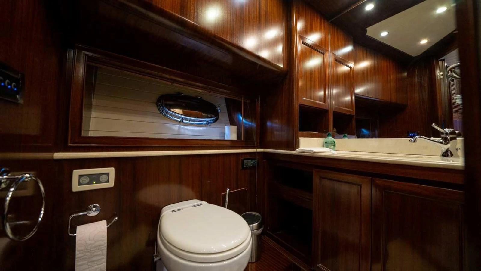 The yacht's bathroom features rich wooden cabinetry and modern fixtures, creating a warm and elegant atmosphere. aboard SILVER Yacht for Sale