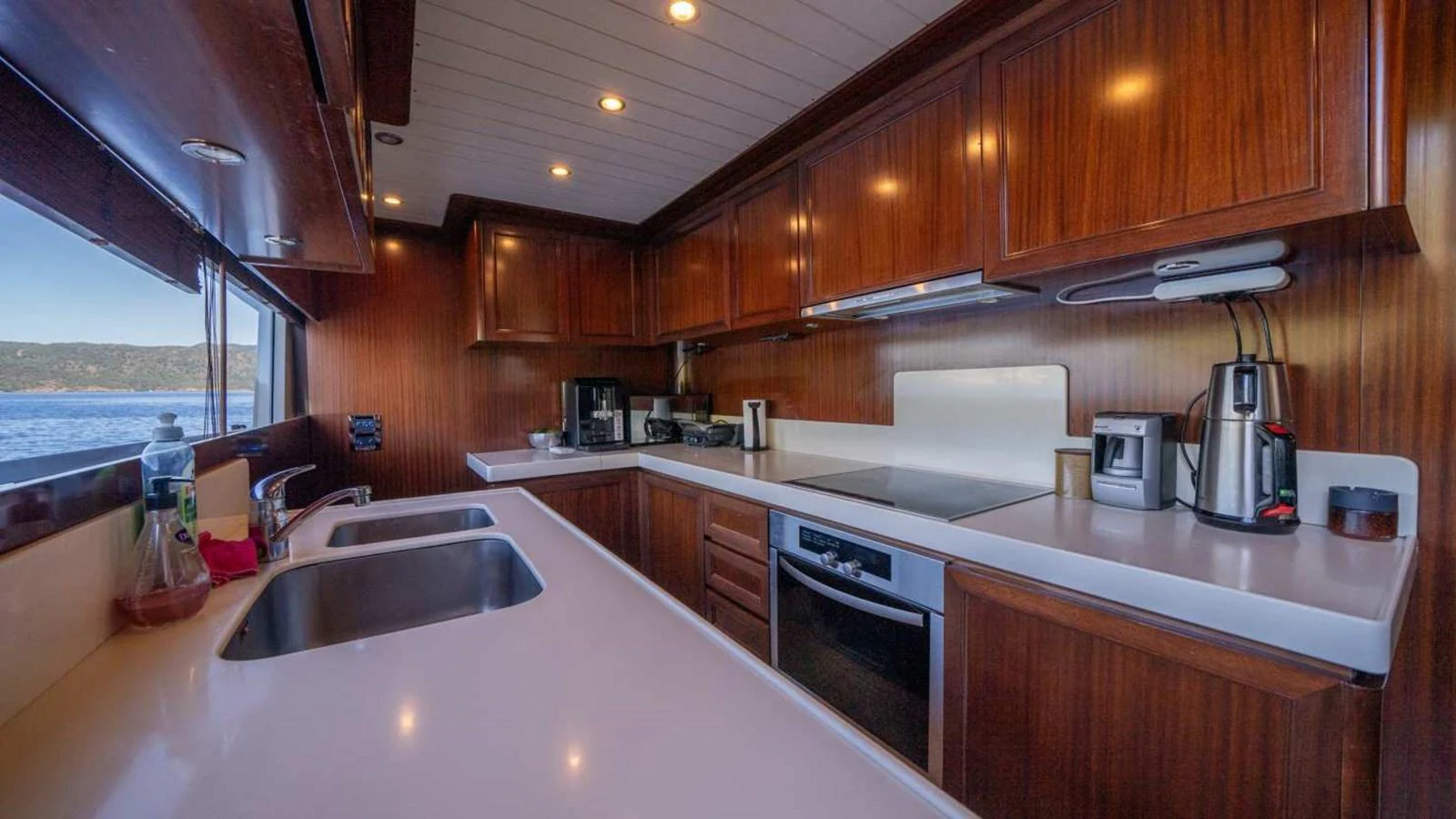 The yacht's galley features sleek wooden cabinetry and modern appliances, offering a sophisticated space for culinary endeavors. aboard SILVER Yacht for Sale