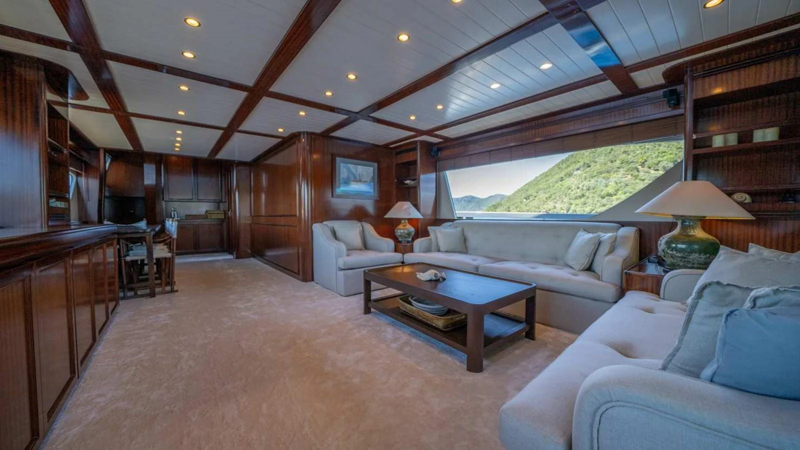 The salon features luxurious seating with ample natural light and elegant wooden finishes. aboard SILVER Yacht for Sale