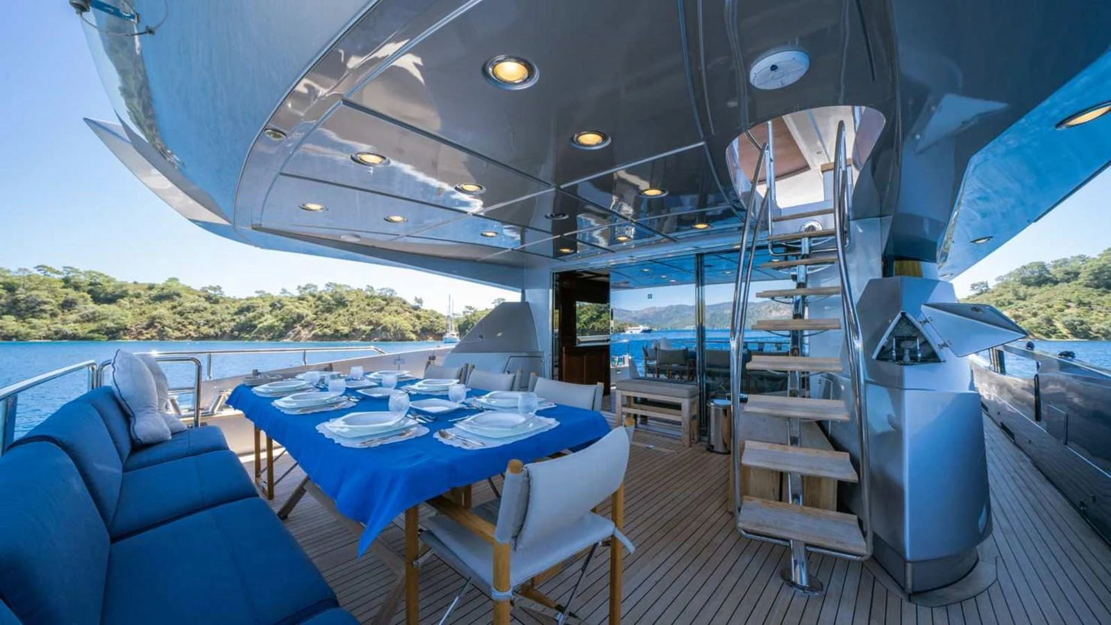 The aft deck features an elegant dining area with a stunning view of the water. aboard SILVER Yacht for Sale