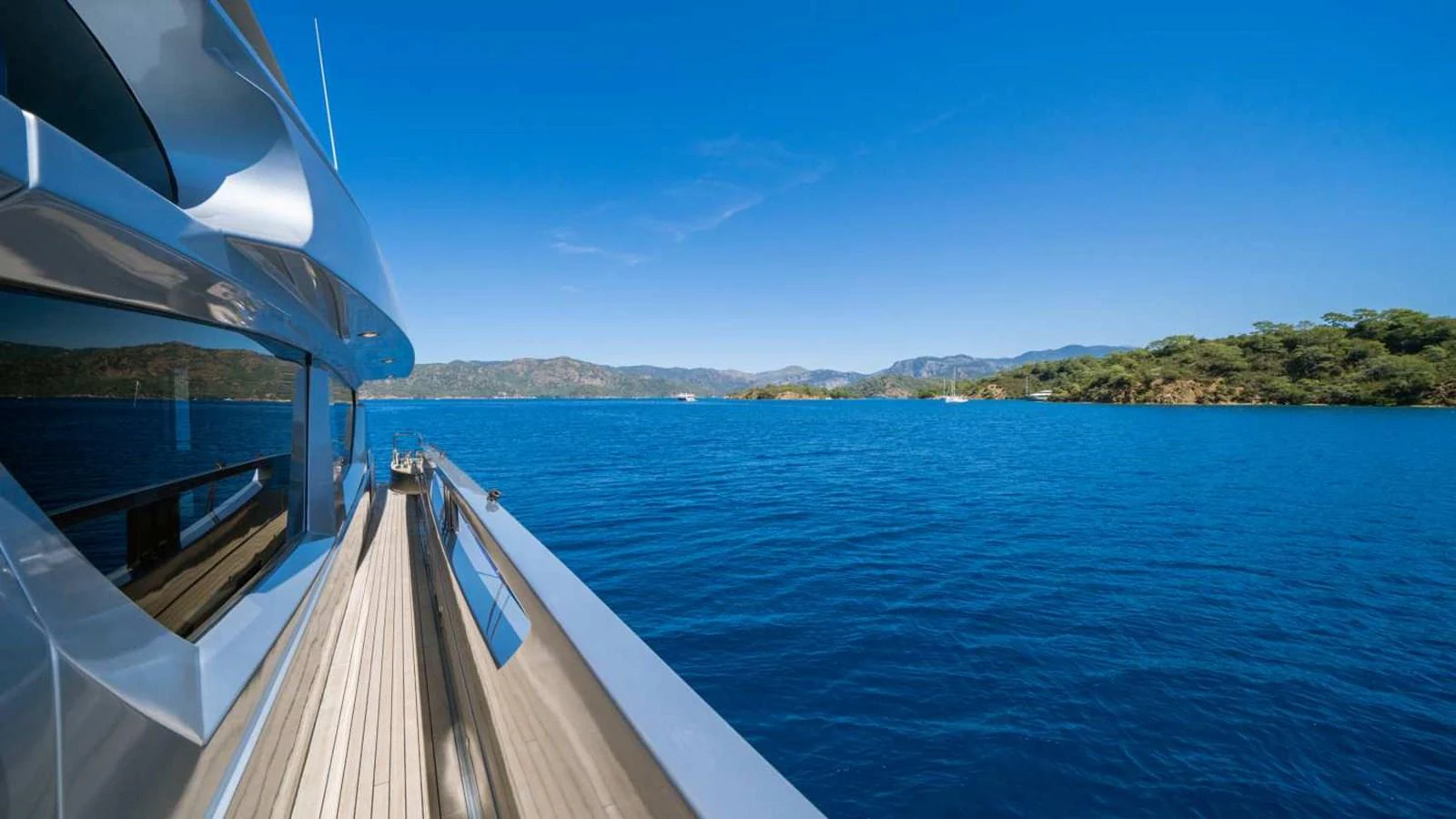 The yacht glides smoothly through serene blue waters, offering a breathtaking view of the surrounding landscape. aboard SILVER Yacht for Sale