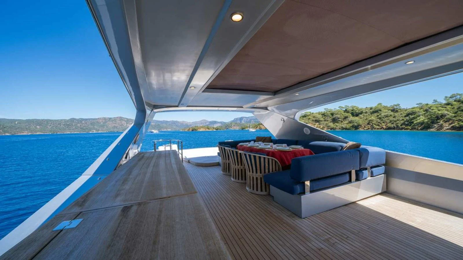 The aft deck offers a spacious and shaded area with comfortable seating and dining arrangements, perfect for enjoying scenic views. aboard SILVER Yacht for Sale