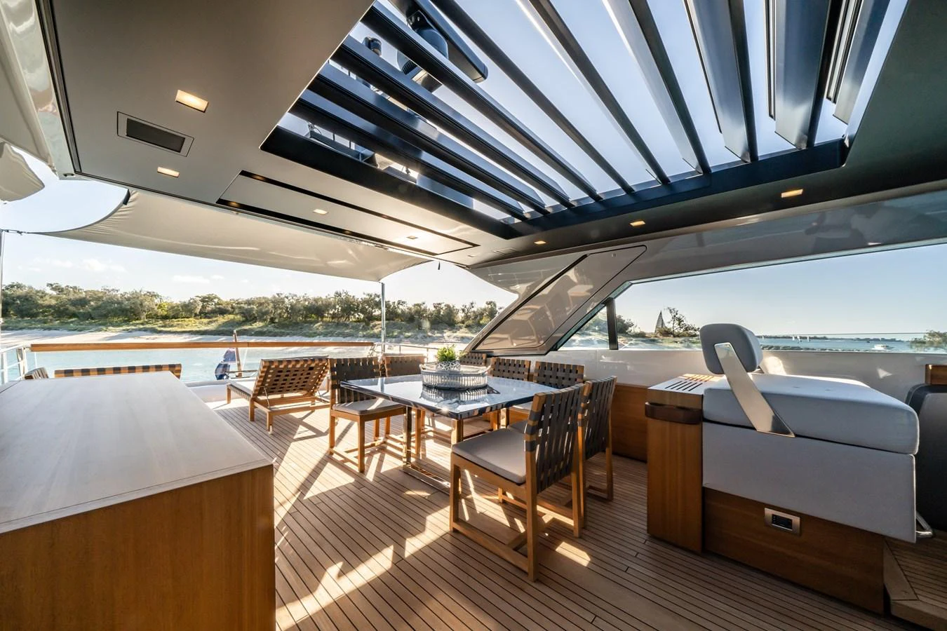 The aft deck features an elegant dining area with a retractable roof, offering a seamless blend of indoor and outdoor living. aboard VIOLETTA Yacht for Sale