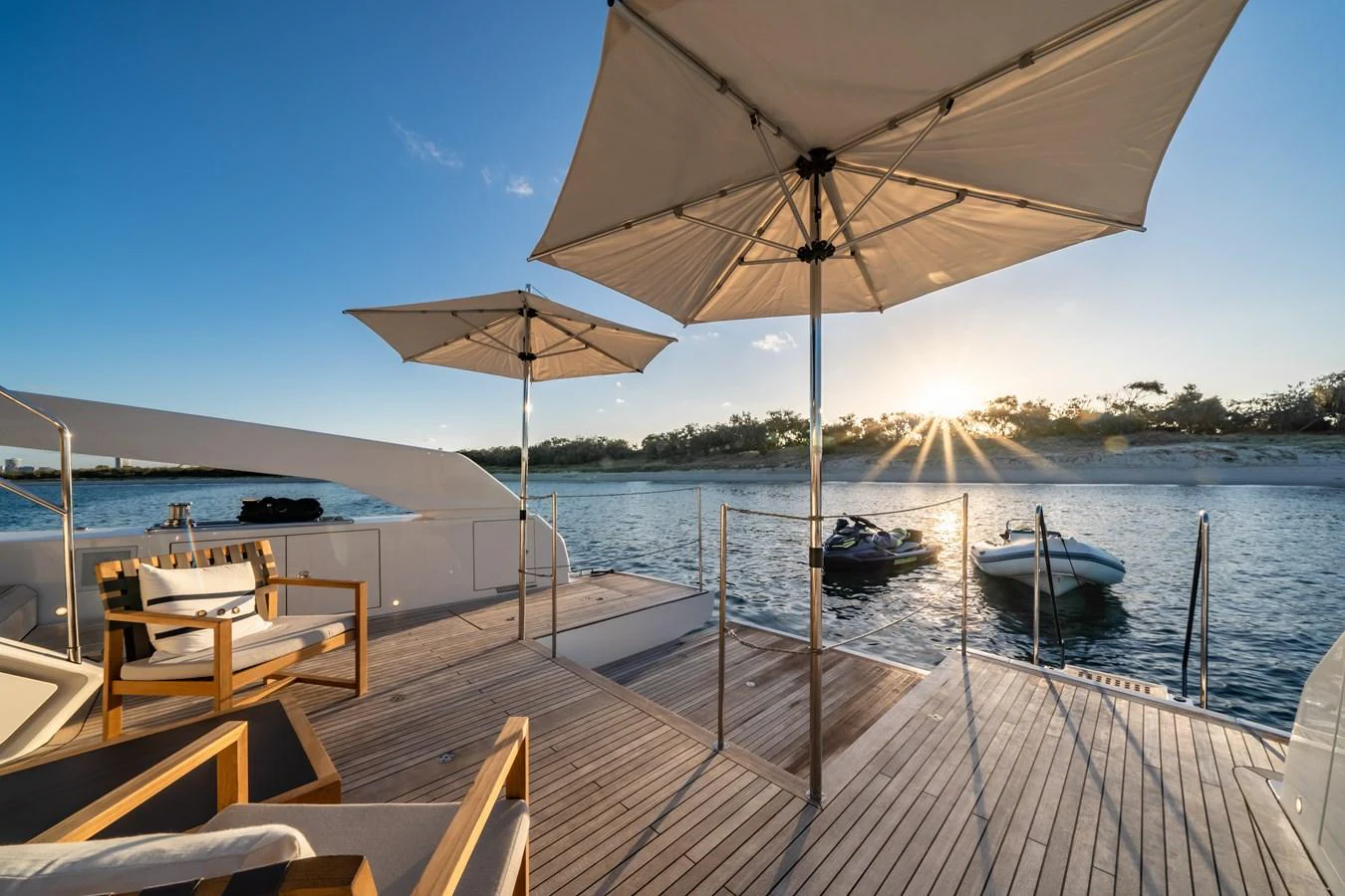 The aft deck offers a serene setting with comfortable seating and stunning views of the water at sunset. aboard VIOLETTA Yacht for Sale