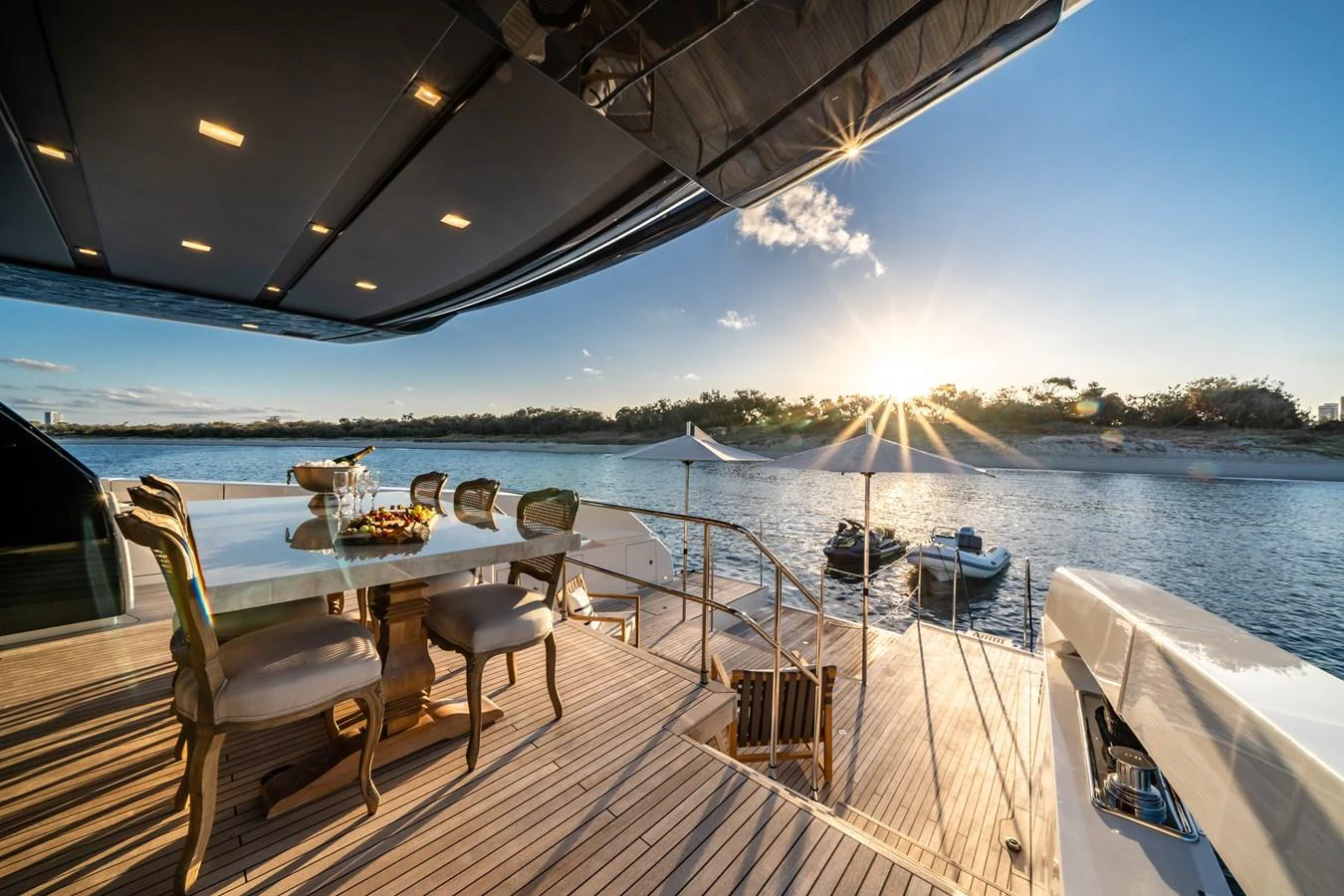 The aft deck offers a luxurious dining area with stunning waterfront views. aboard VIOLETTA Yacht for Sale