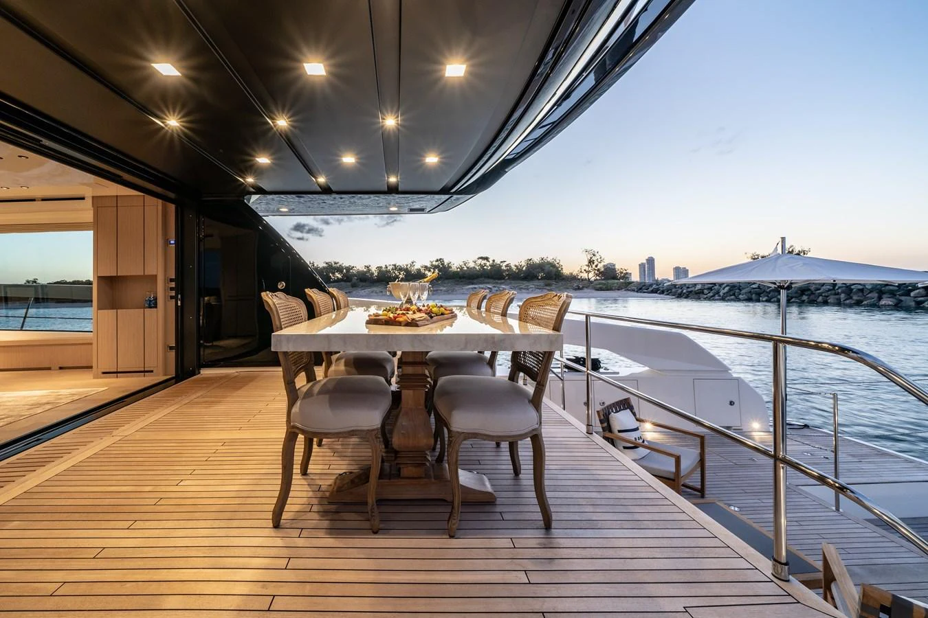 The aft deck features an elegant dining area with a stunning view of the water. aboard VIOLETTA Yacht for Sale
