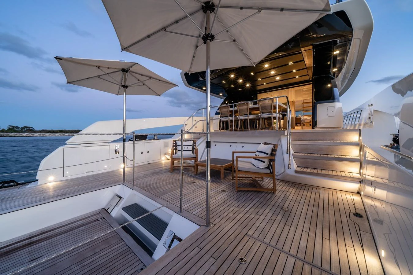 The spacious aft deck features elegant seating and umbrellas, perfect for outdoor relaxation and dining. aboard VIOLETTA Yacht for Sale