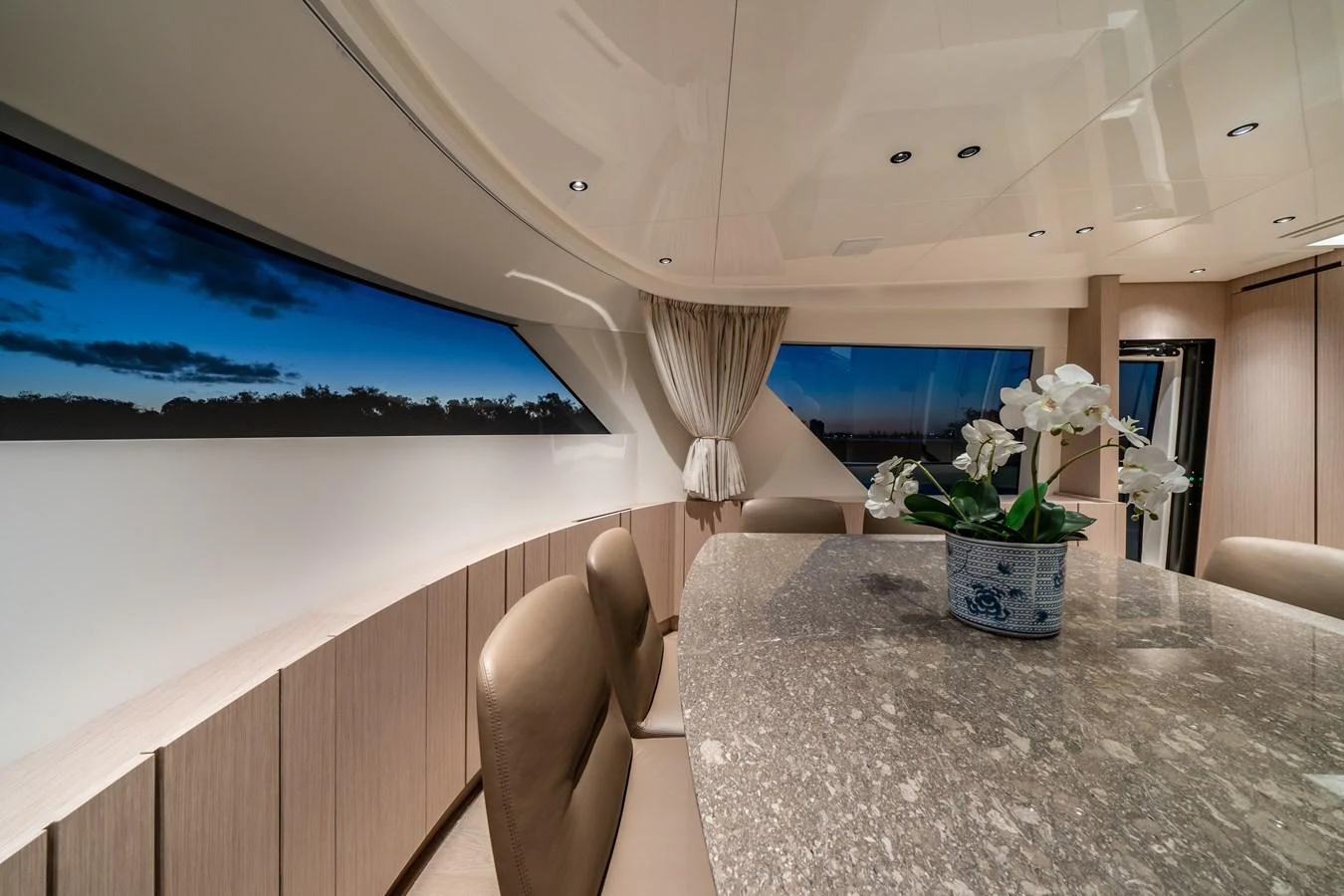 The yacht's interior features a sophisticated dining area with a large table and elegant decor. aboard VIOLETTA Yacht for Sale