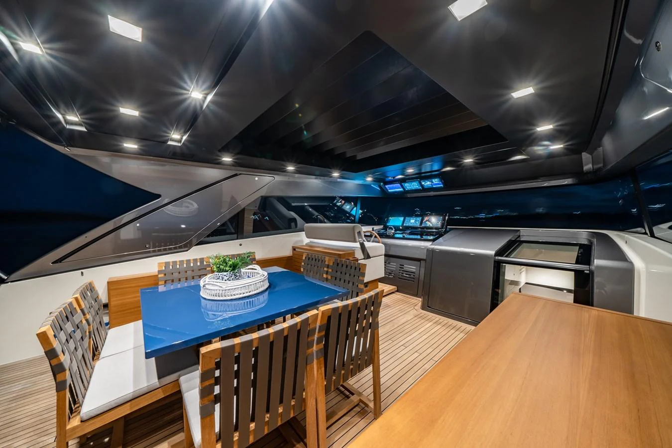 The yacht's dining area features a stylish table with comfortable seating, set under a sleek, modern ceiling with ambient lighting. aboard VIOLETTA Yacht for Sale