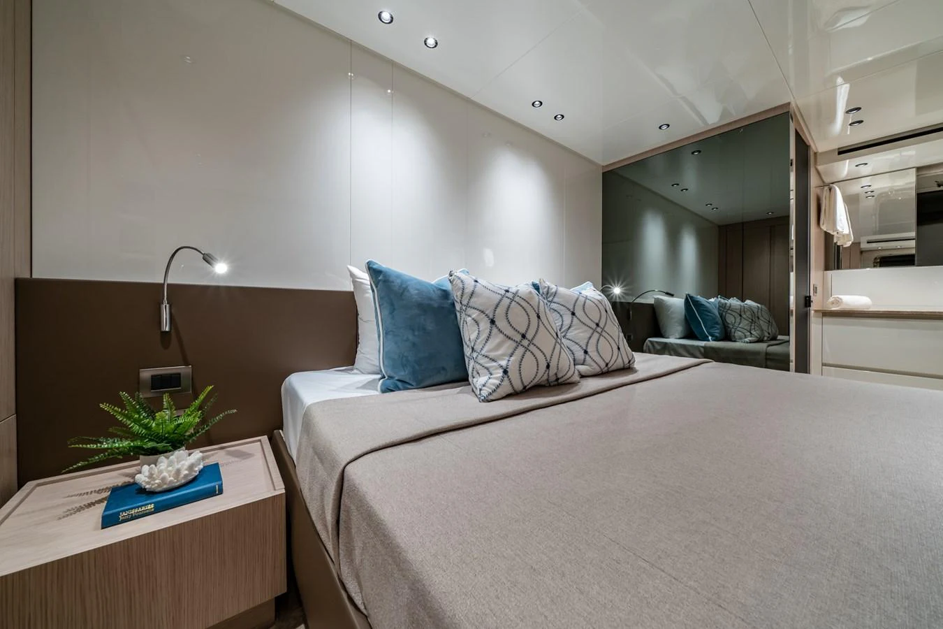 A cozy and elegantly designed stateroom featuring a comfortable bed with plush pillows and modern lighting. aboard VIOLETTA Yacht for Sale