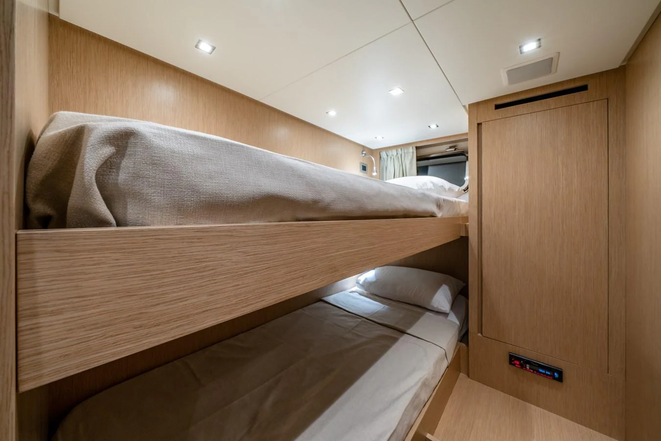 The cozy bunk cabin features sleek wooden finishes and modern lighting. aboard VIOLETTA Yacht for Sale