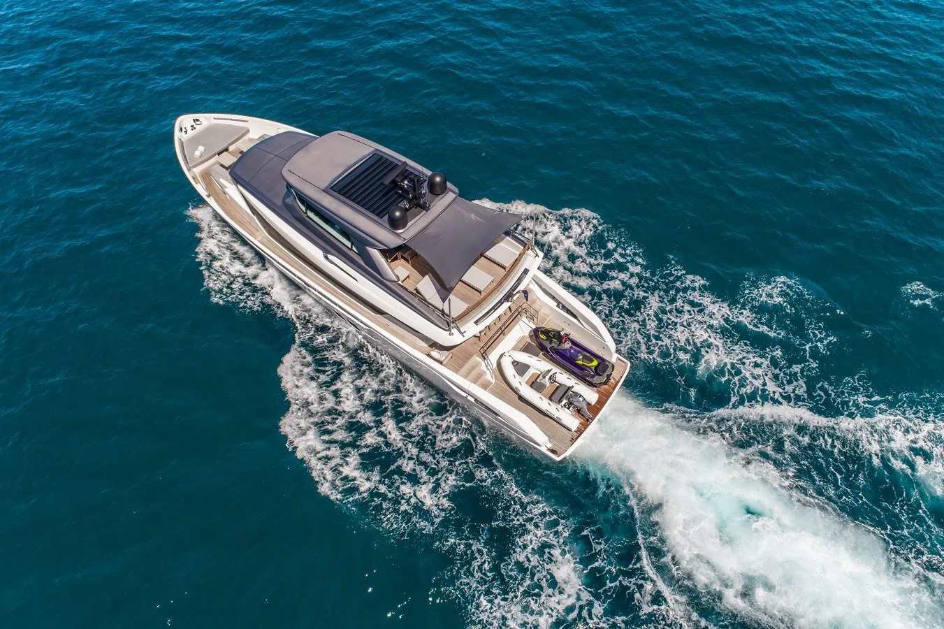 A sleek yacht cruises through the open water, showcasing its modern design and spacious deck. aboard VIOLETTA Yacht for Sale