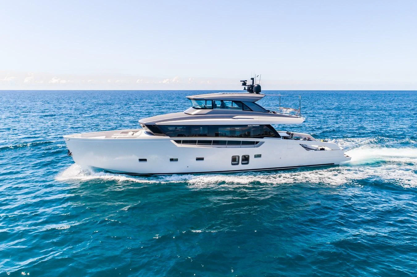 A sleek and modern yacht cruising on the open sea under a clear blue sky. aboard VIOLETTA Yacht for Sale