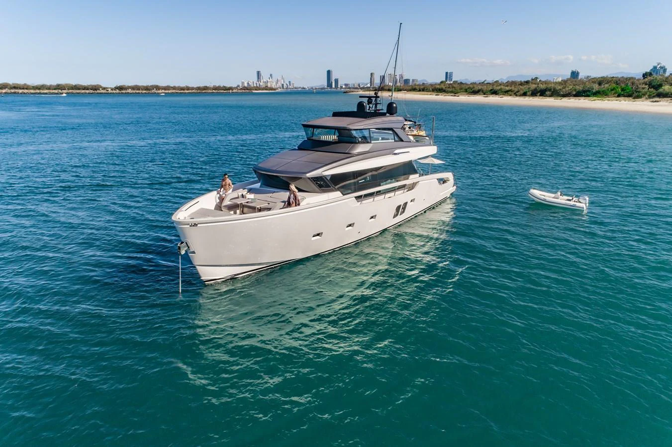 A sleek and modern yacht cruises gracefully on calm waters with a tender nearby. aboard VIOLETTA Yacht for Sale