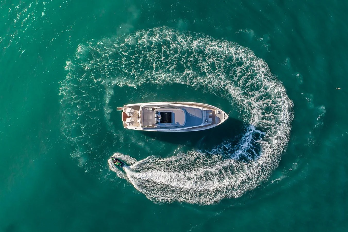An aerial view of a yacht cruising through clear blue waters, leaving a trail of white wake behind. aboard VIOLETTA Yacht for Sale