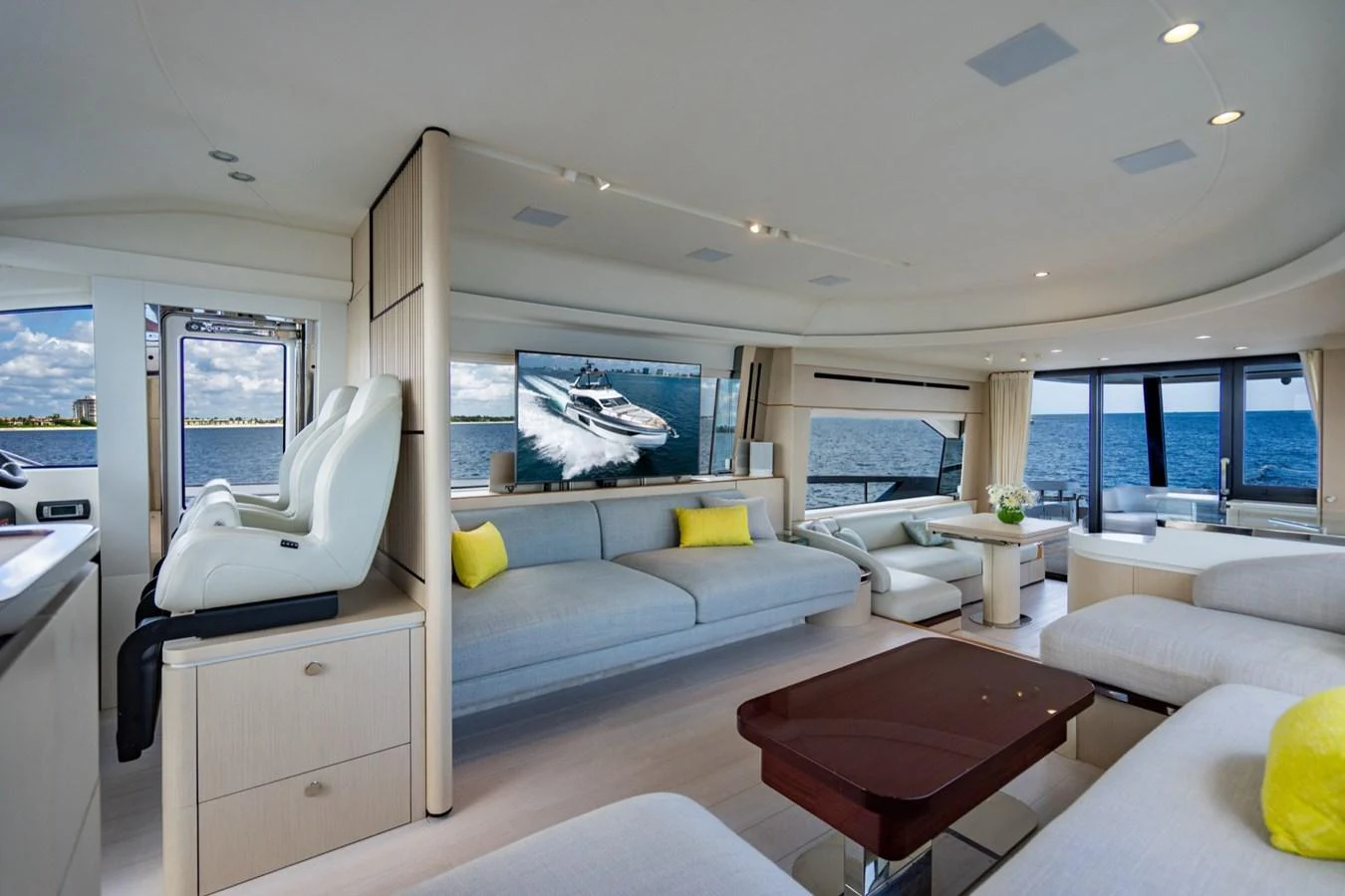 The spacious salon features modern furnishings and panoramic windows offering stunning ocean views. aboard EFFORTLESS Yacht for Sale