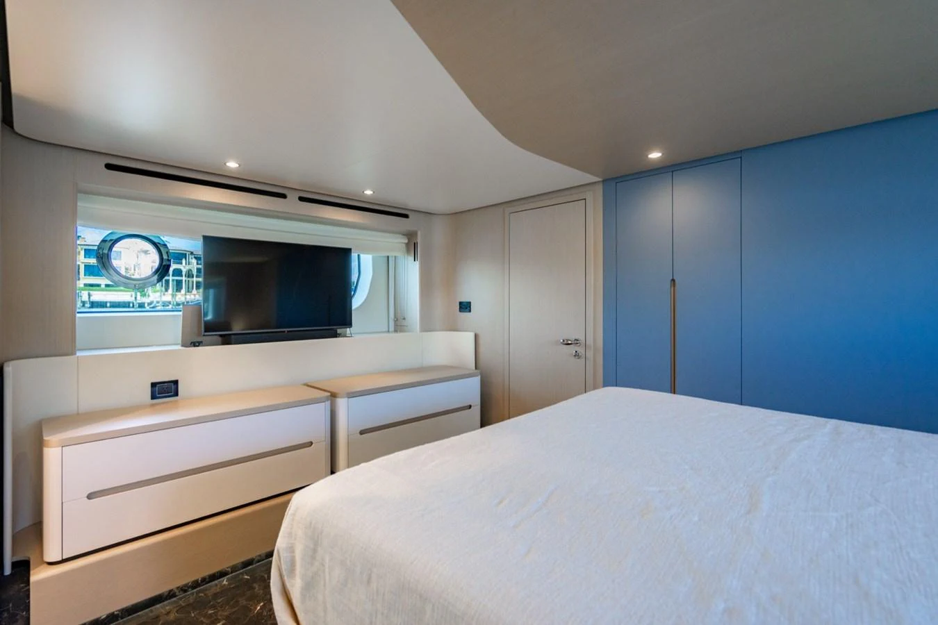 A modern stateroom with a large bed, sleek cabinetry, and a flat-screen TV. aboard EFFORTLESS Yacht for Sale