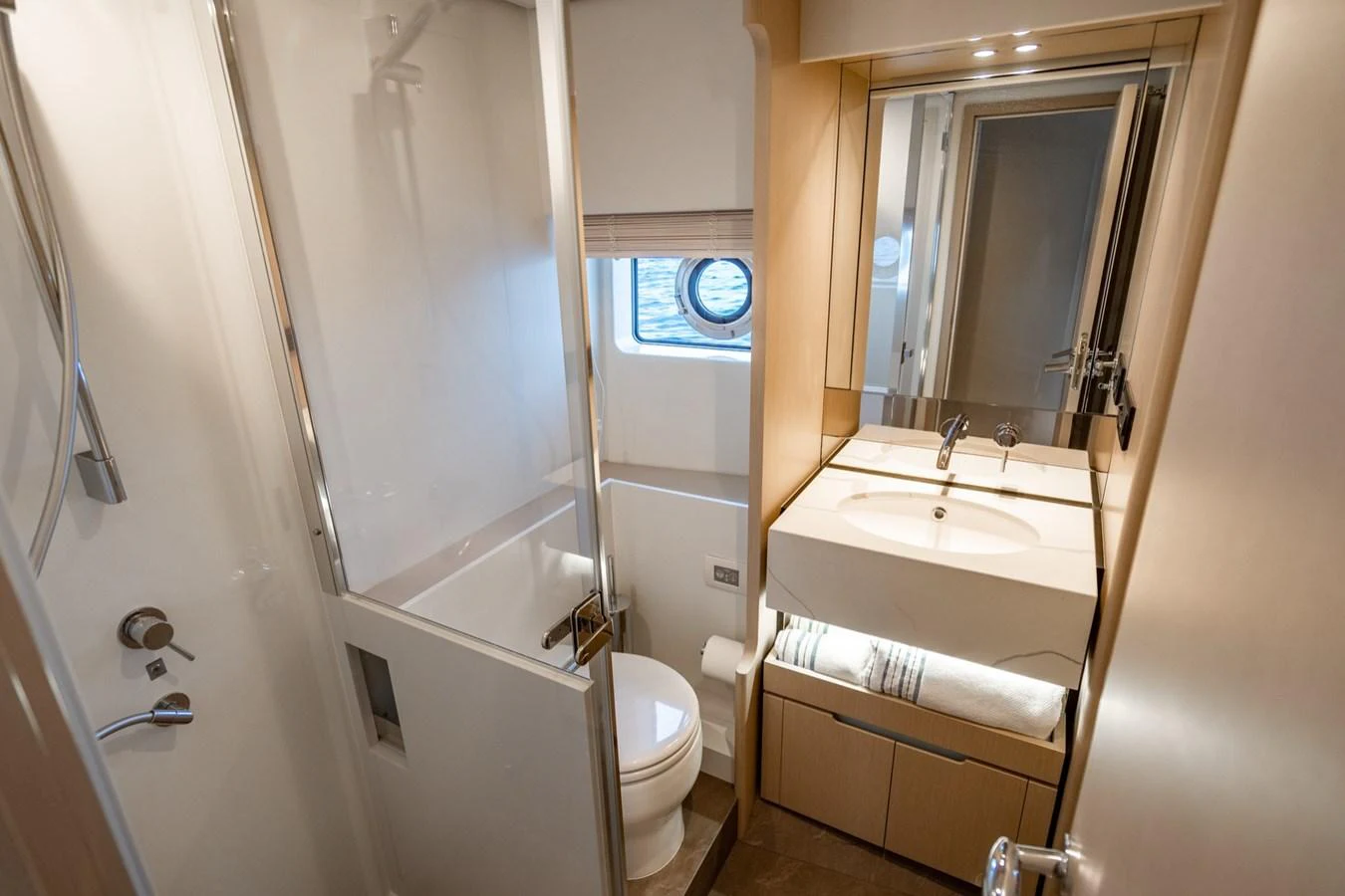 The yacht's bathroom features a modern design with a shower, sink, and toilet. aboard EFFORTLESS Yacht for Sale