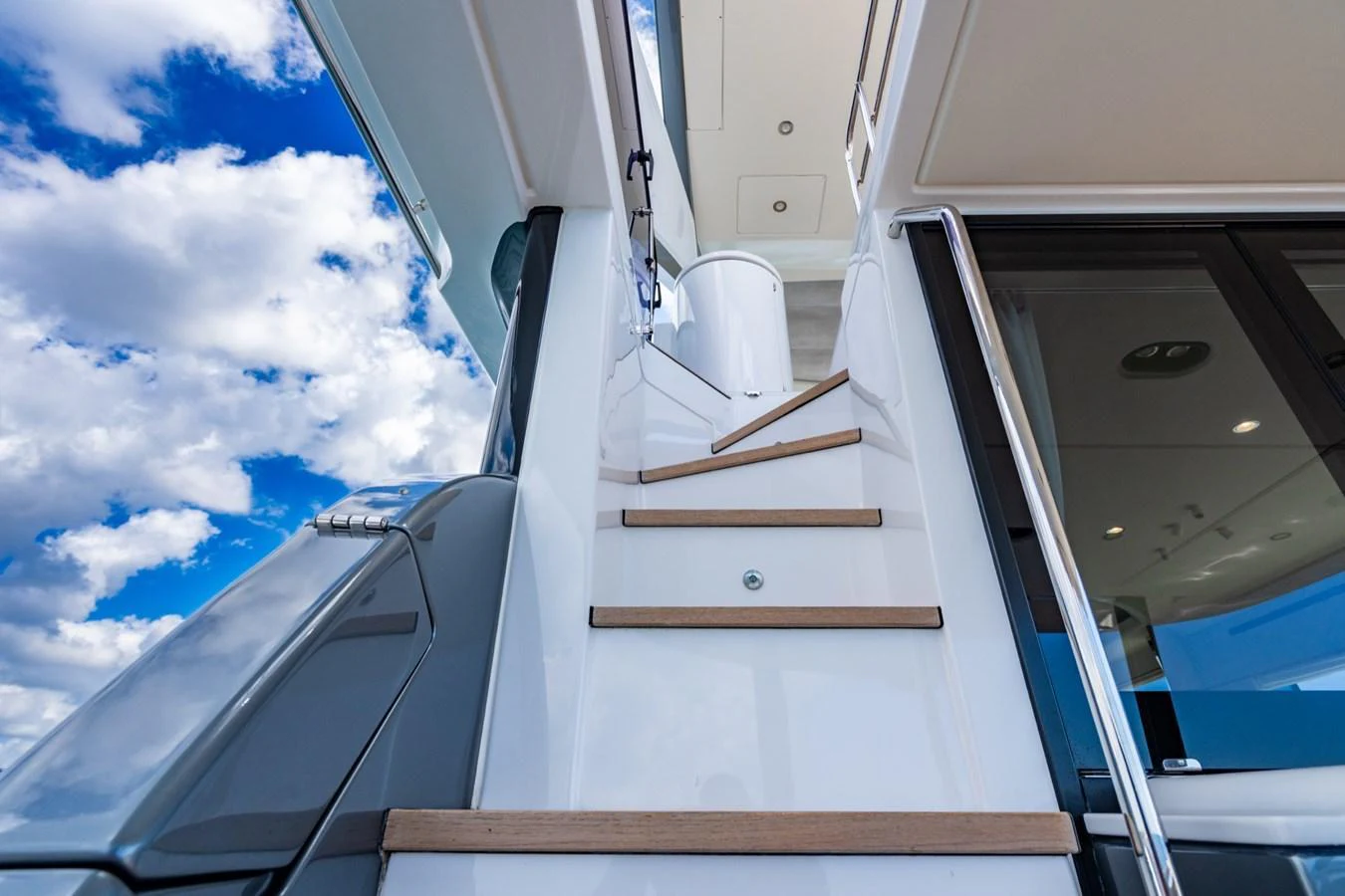 A sleek staircase leads to the upper deck of the yacht, showcasing modern design and craftsmanship. aboard EFFORTLESS Yacht for Sale