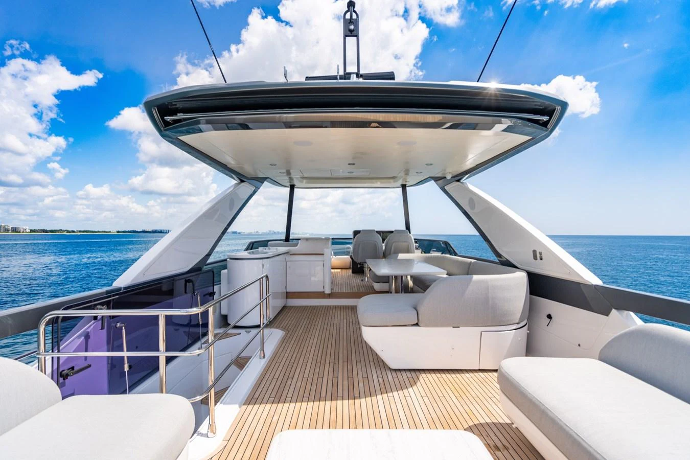 The yacht's flybridge offers a spacious and luxurious outdoor living area with ample seating and stunning ocean views. aboard EFFORTLESS Yacht for Sale