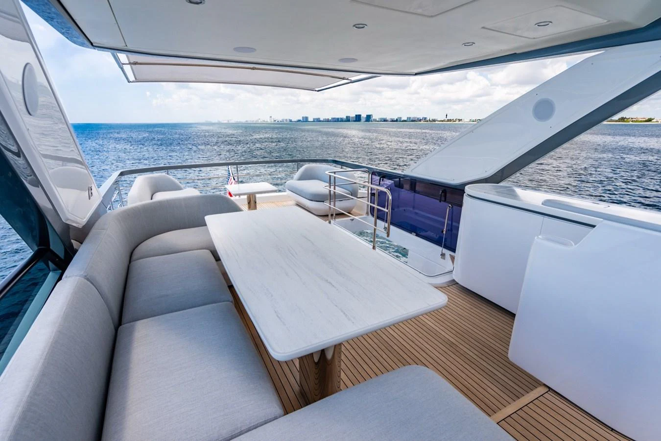 The aft deck offers a spacious and comfortable seating area with a stunning view of the ocean. aboard EFFORTLESS Yacht for Sale
